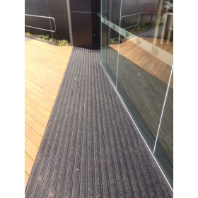 Insitu image of the Designa Vinyl Architectural Mat Tiles in a office block entrance and installed into the floor,