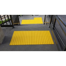 Insitu image of the yellow tactile tiles used in a staircase for stability and danger warning for foot traffic